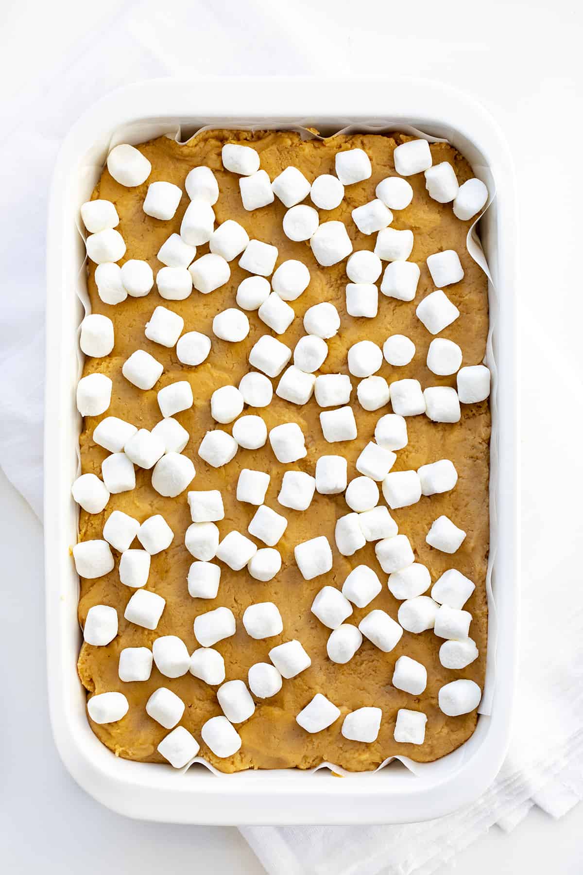Pan of Completed Fluffernutter Fudge that Shows Peanut Butter Fudge Topped with Mini Marshmallows on White Counter. 