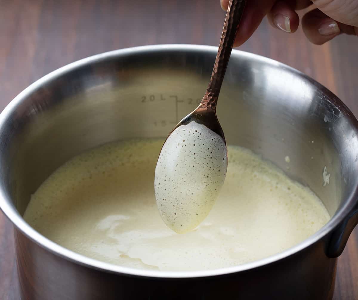 Eggnog mixture coating the back of a spoon.
