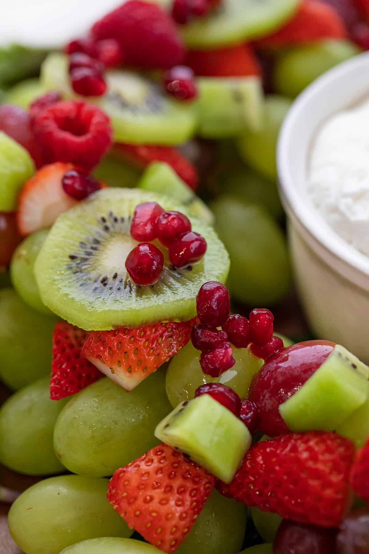 Close up of Kiwi, Strawberries, and Pomegranate.