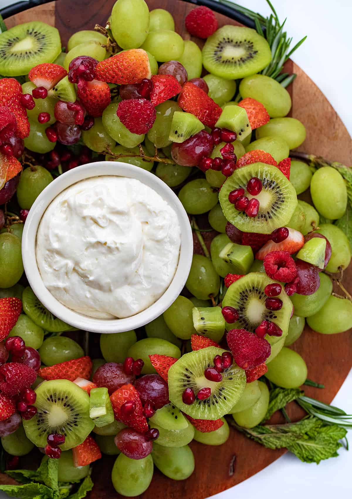 Close up of Holiday Wreath Fruit Tray with Red and Green Fruit and Fruit Dip.