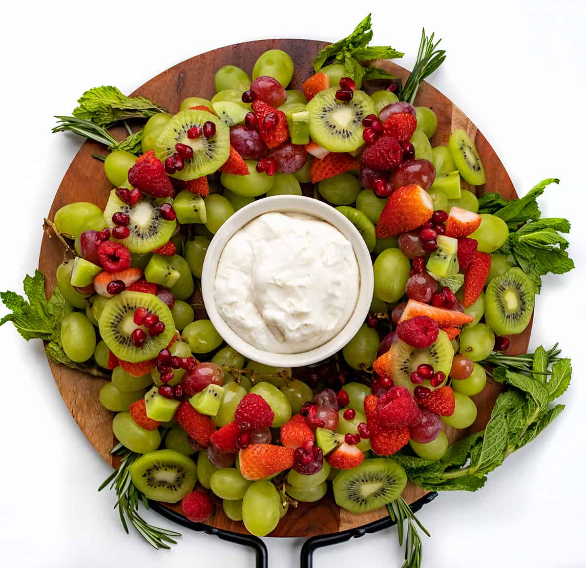 A Holiday Wreath Fruit Tray on a Round Cutting Board.