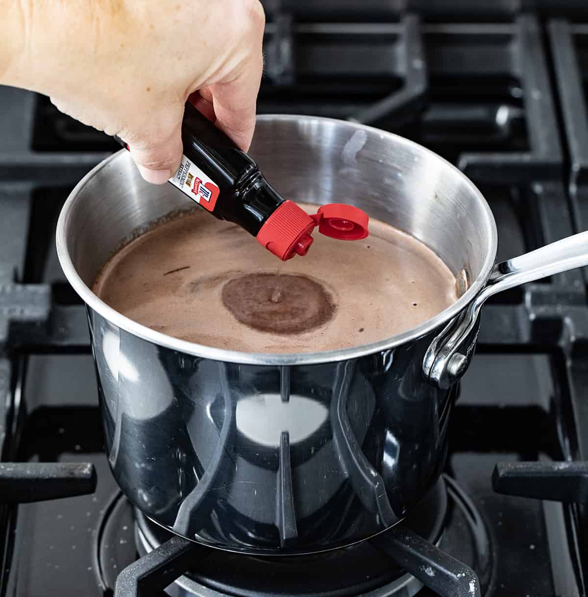 Adding Peppermint Extract to Melted Chocolate in a Saucepan.
