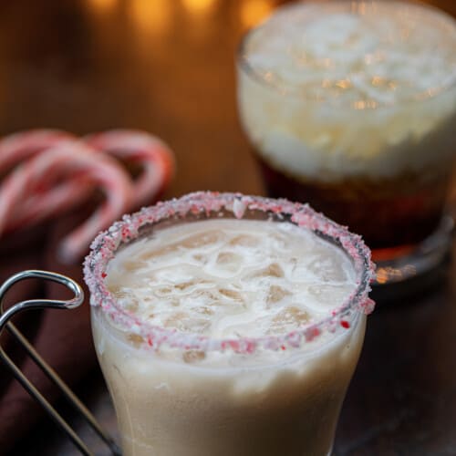 Peppermint White Russians in front of a Christmas Tree and Twinkling Lights.