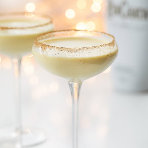 Glasses of RumChata Eggnog in Front of Twinkling Lights.