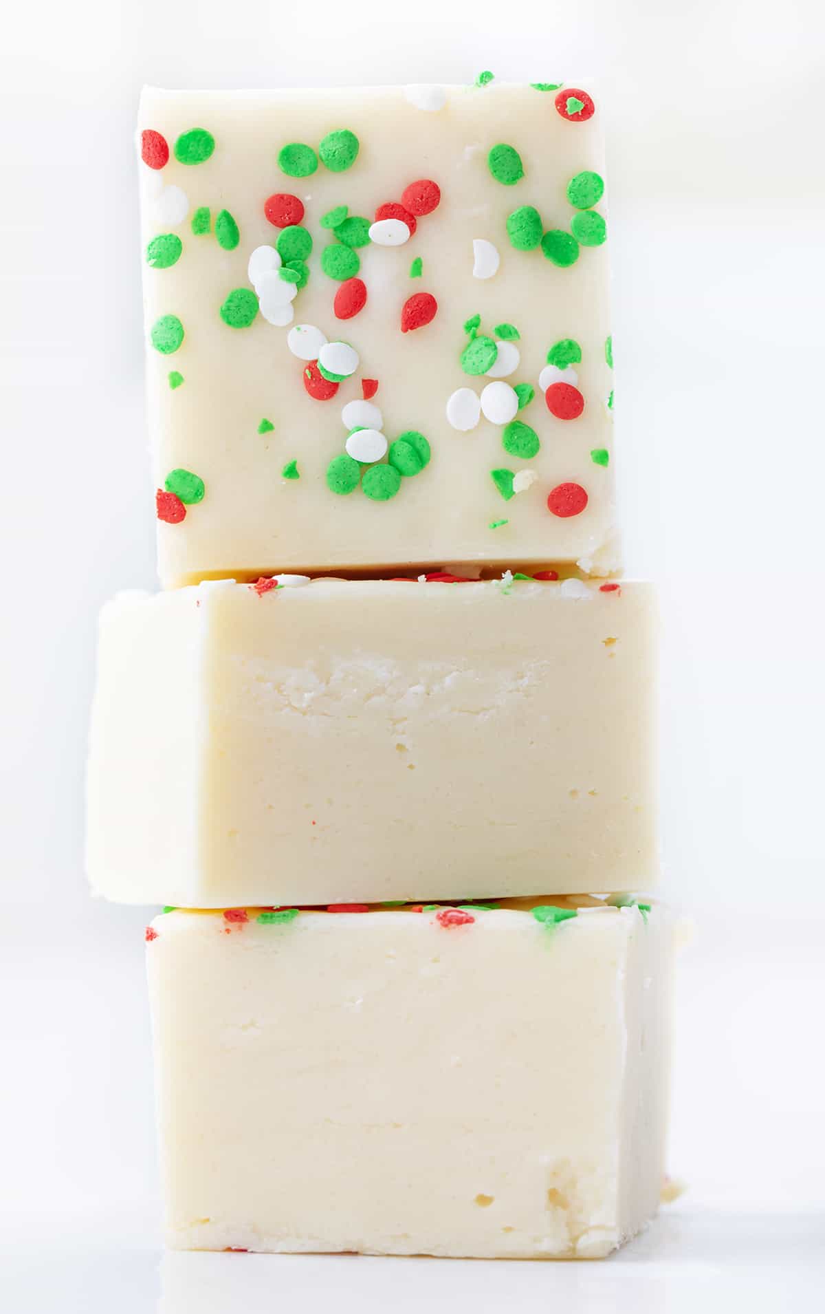 Stack of Pieces of Sugar Cookie Fudge on a White Counter.