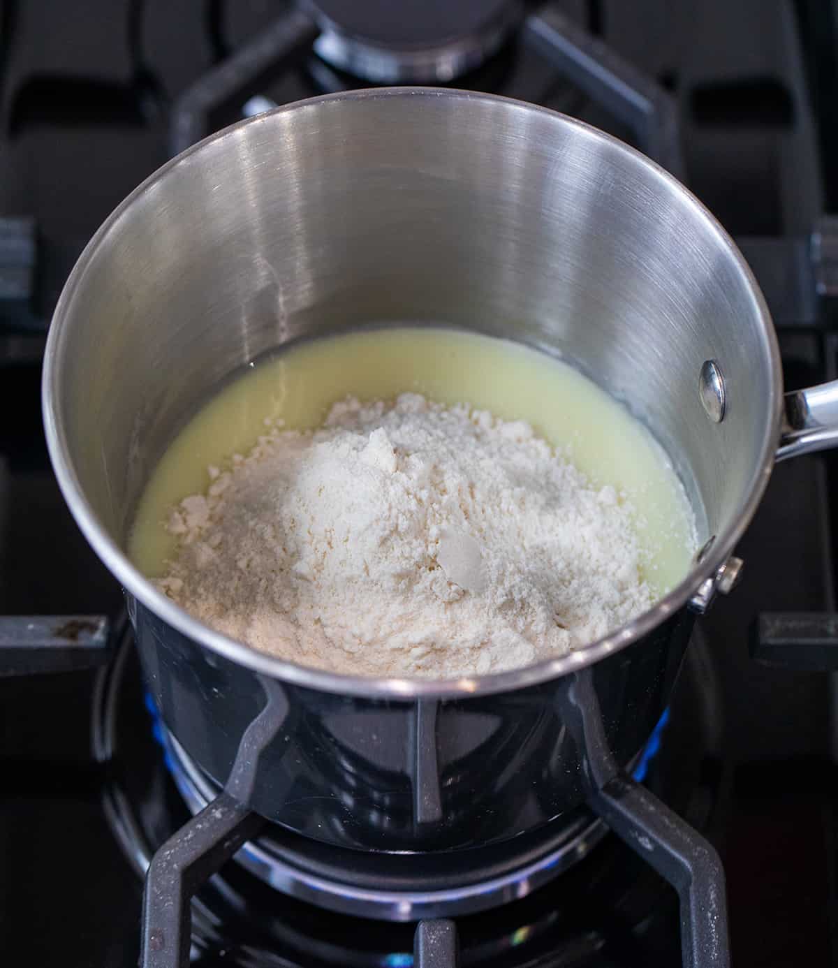 Mixing ingredients for Sugar Cookie Fudge over heat.