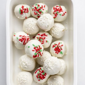 White and Red and Green Sprinkles on Sugar Cookie Truffles in a White Dish.
