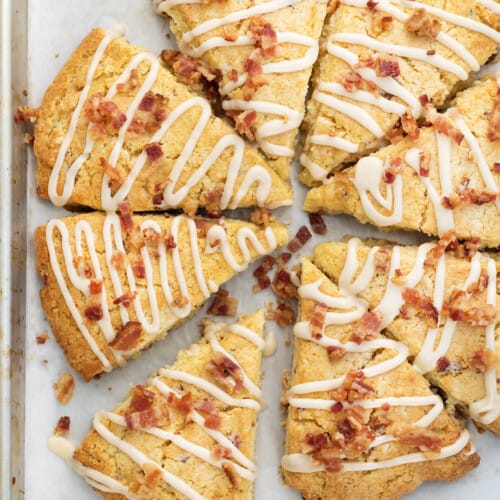 Sheet Pan with Maple Bacon Scones Drizzled with Maple Glaze and Sprinkled with Bacon.