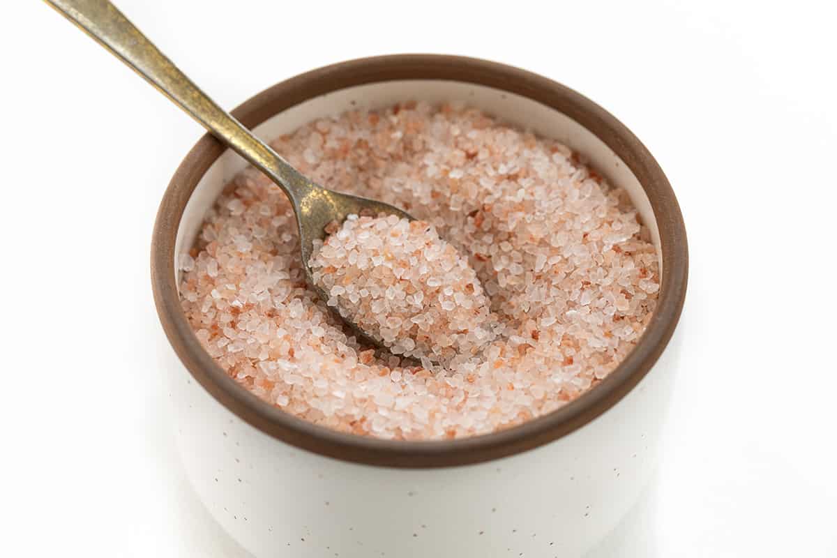 A Container of Himalayan Salt with a Spoon in it.
