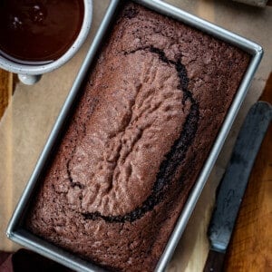 Overhead Image of Brownie Bread with a Knife and Chocolate Glaze for on Top.
