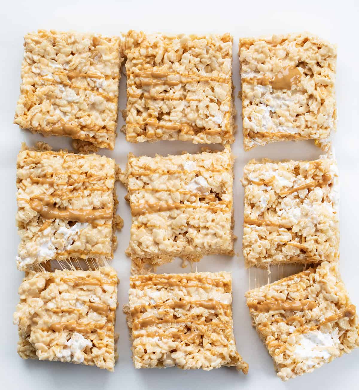 Fluffernutter Rice Krispie Bars on a White Counter Cut into 9 Pieces and Slightly Spread Out. 