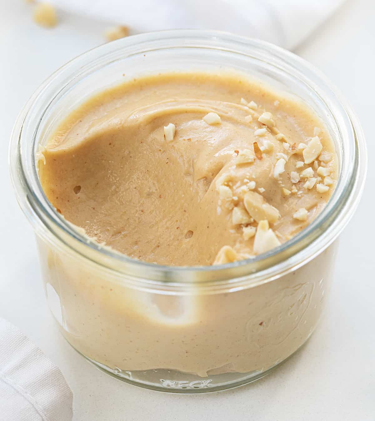 Container of Peanut Butter Mousse with a Spoonful Removed Showing More Texture.