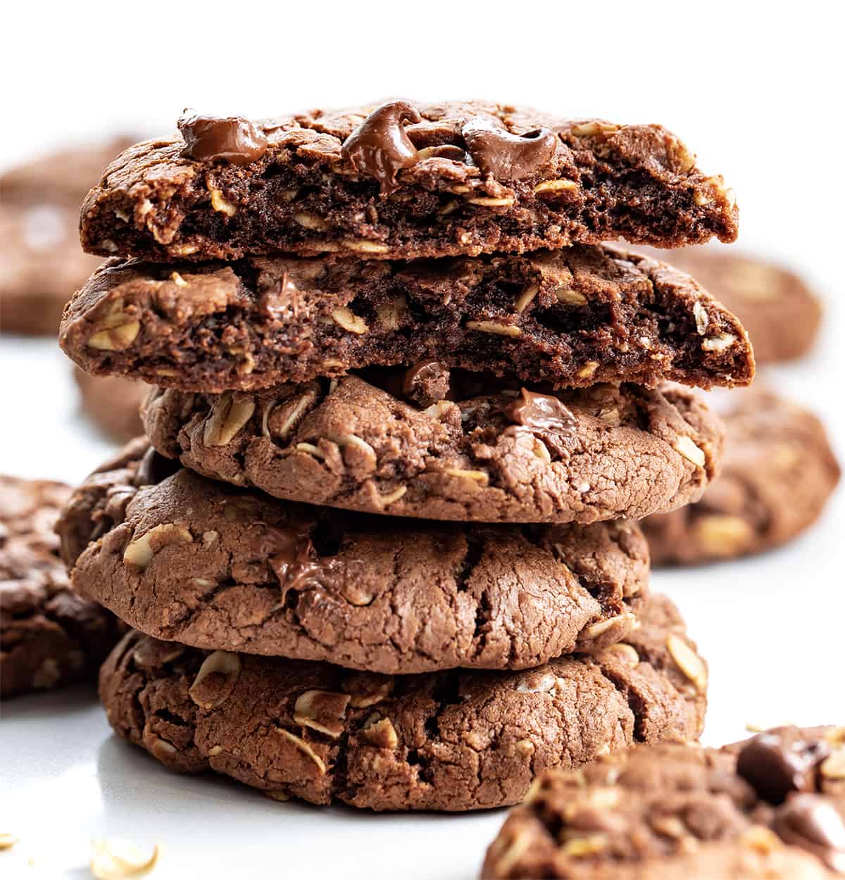 Stack of Chocolate Oatmeal Cookies with Top Cookie Broken in Half.