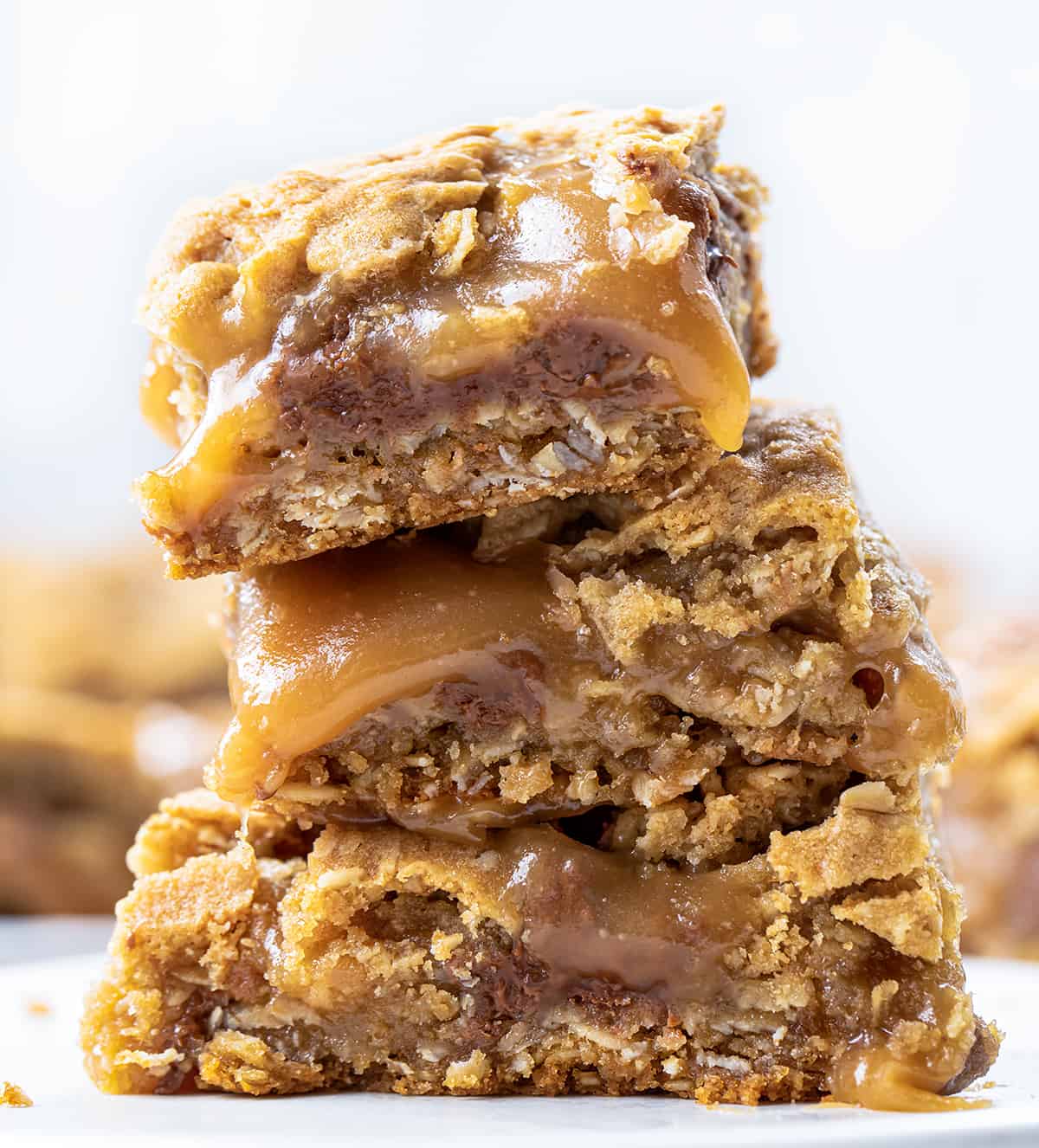 Chocolate Caramel Oatmeal Cookie Bars Stacked on Top of Each Other.