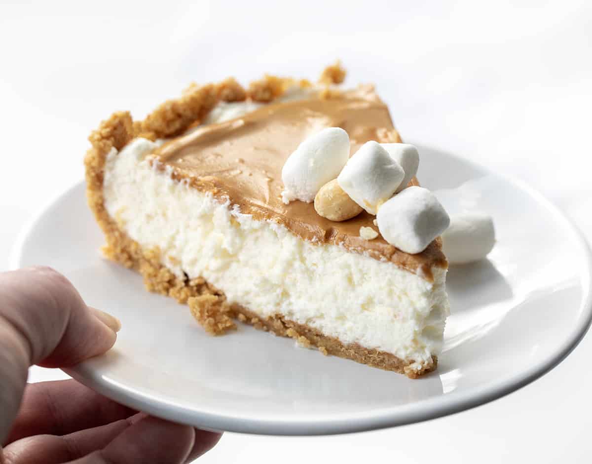 Hand Holding White Plate with Fluffernutter Pie on It. 