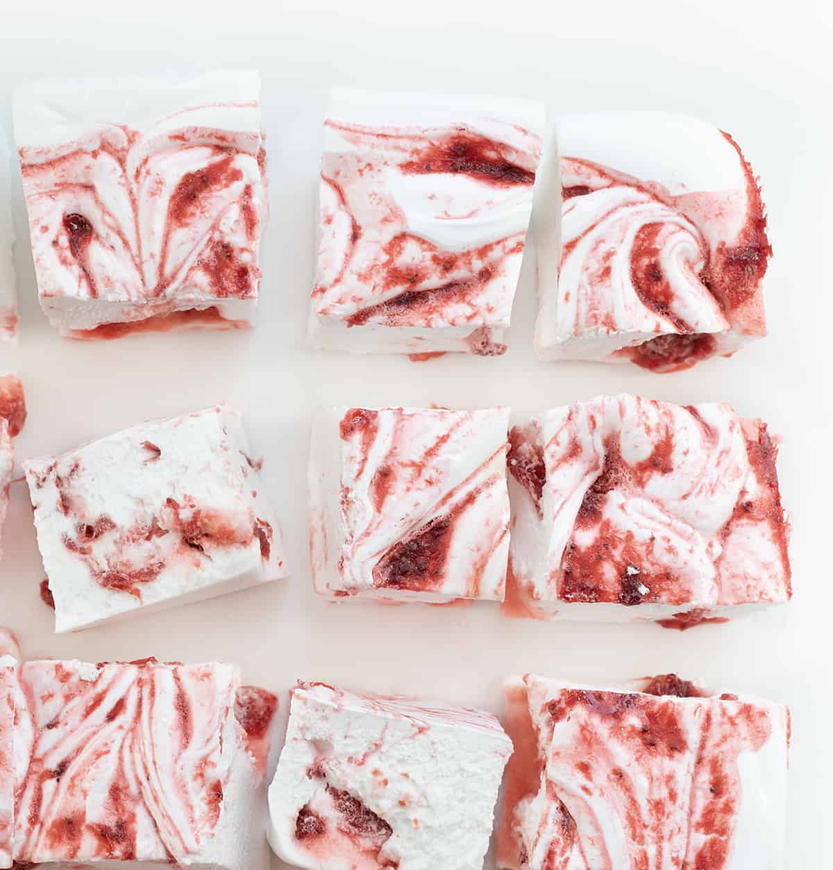 Strawberry Marshmallows from Overhead Cut into Pieces and on a White Counter.