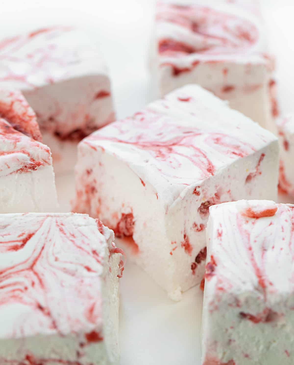 Cut up Strawberry Marshmallows on a White Counter.