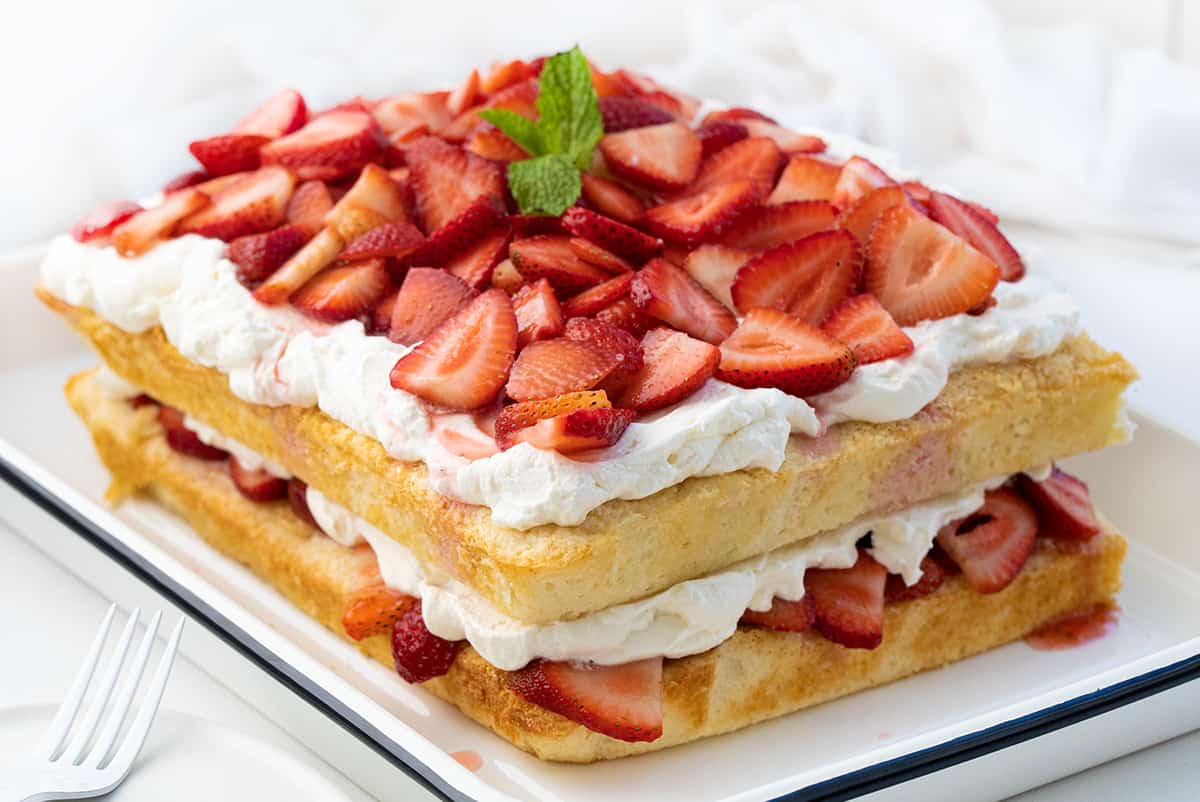 Sheet Pan Strawberry Shortcake in a Pan on a White Counter Turned at an Angle.