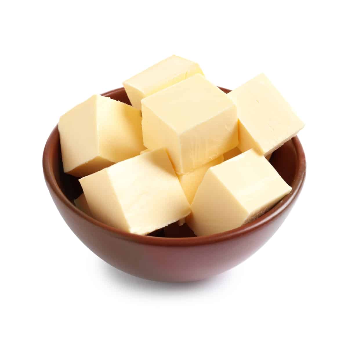 Bowl of cubed Butter on a White Counter.