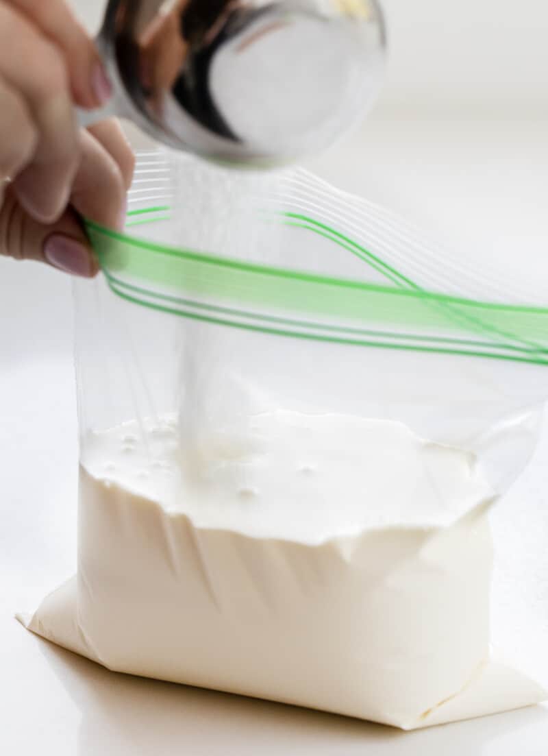 Adding Sugar to a Bag Filled with Heavy Cream to Make Soft Serve Ice Cream.