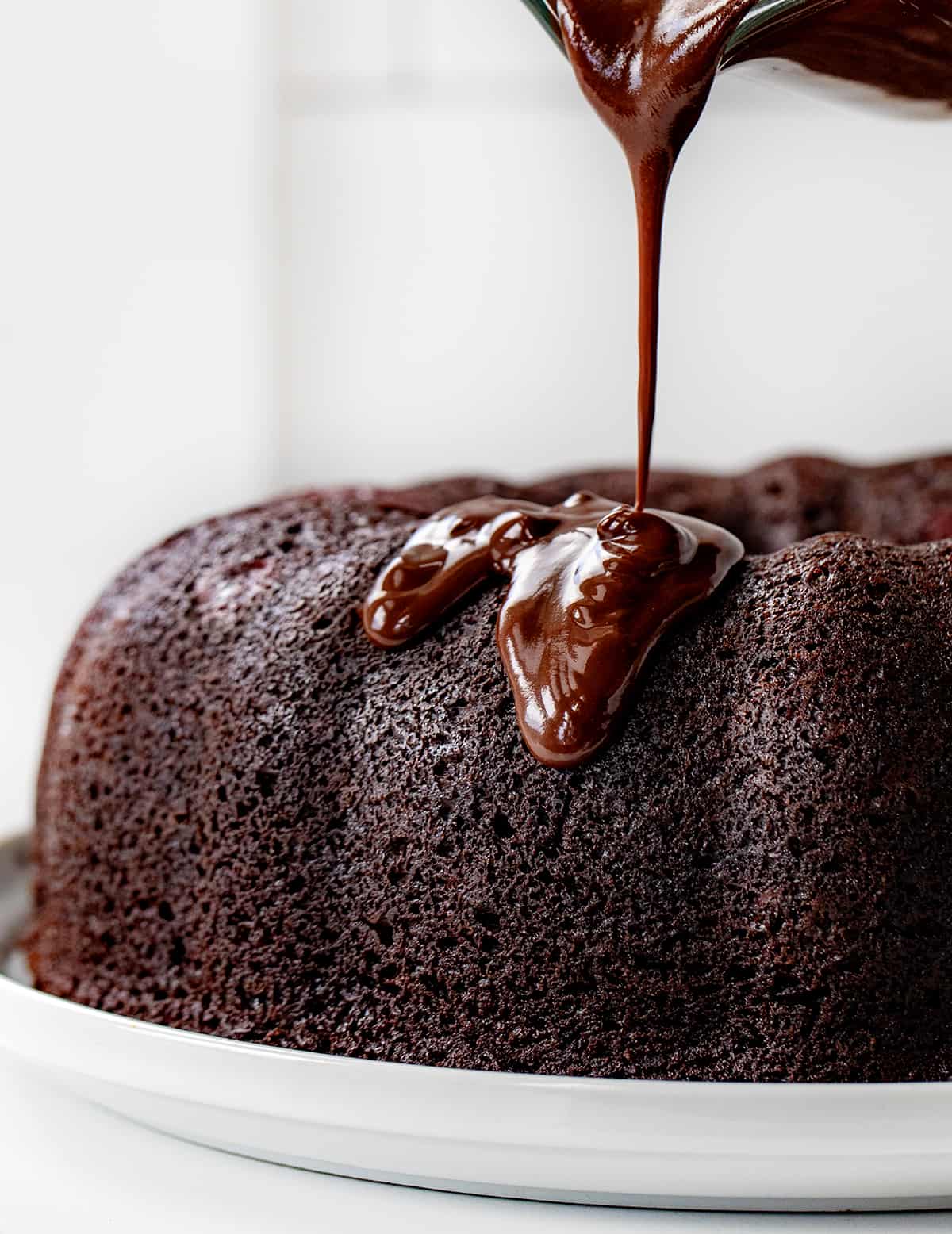 Pouring Chocolate Ganache Over a Naked Chocolate Bundt Cake.