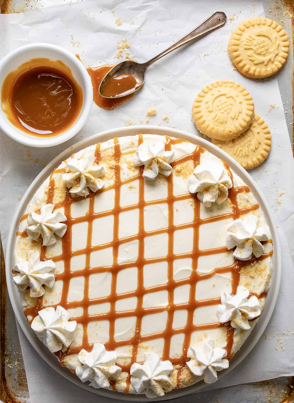Caramel Cheesecake from Overhead with some Shortbread Cookies and Caramel Nearby.