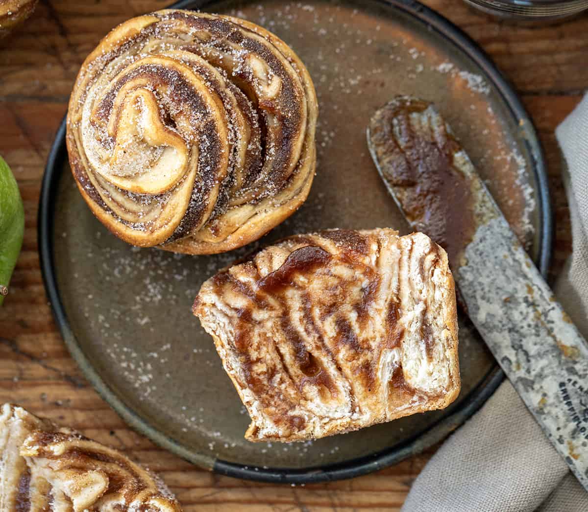 Apple Butter Cruffins on a Plate with One Cut in Half and More Apple Butter.