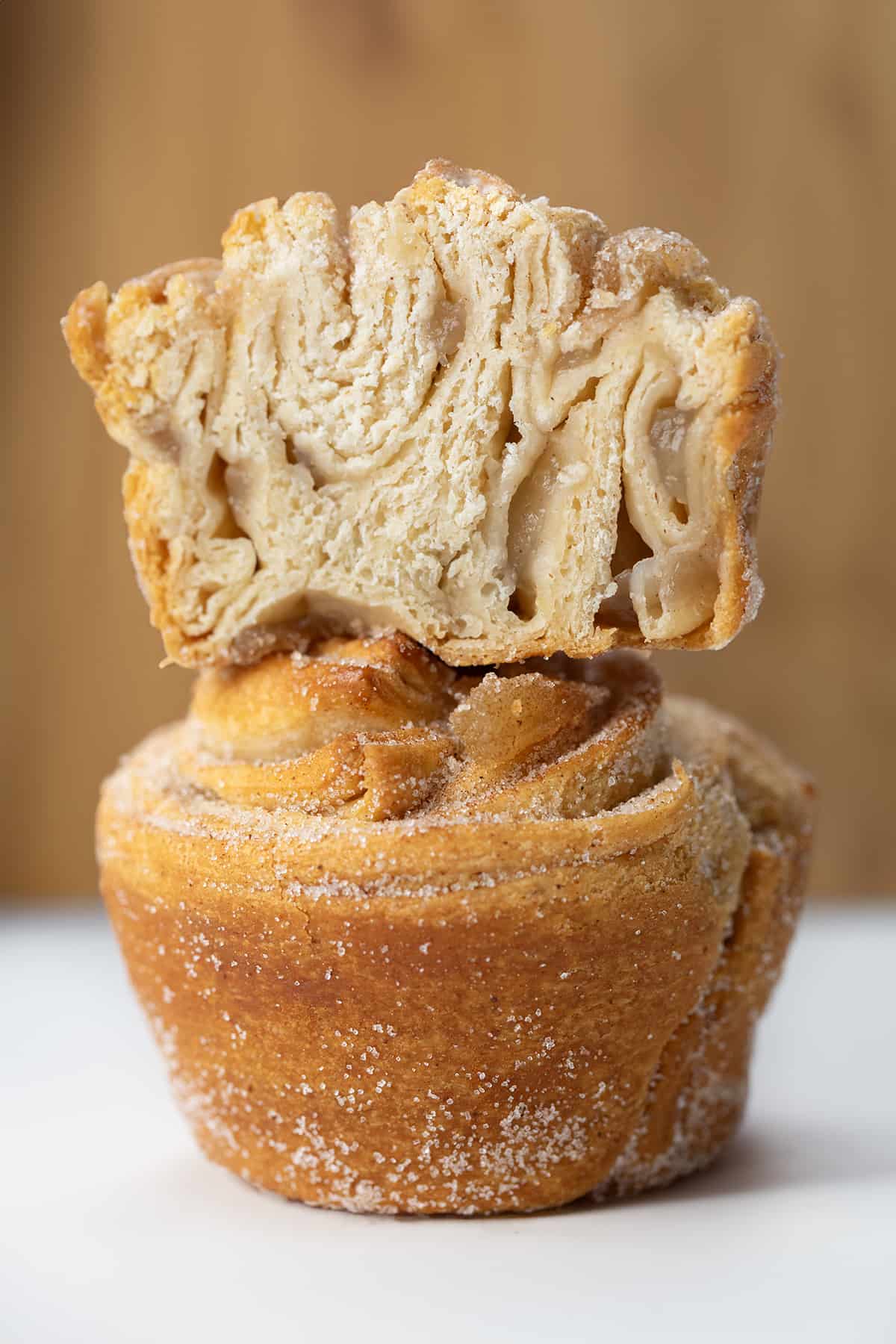 Stacked Apple Pie Cruffins with the top muffin cut in half.