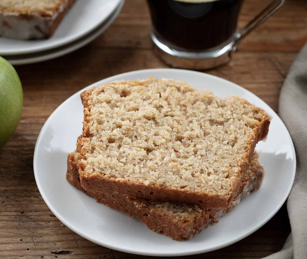 Slices of Applesauce Bread on a plate next to coffee.