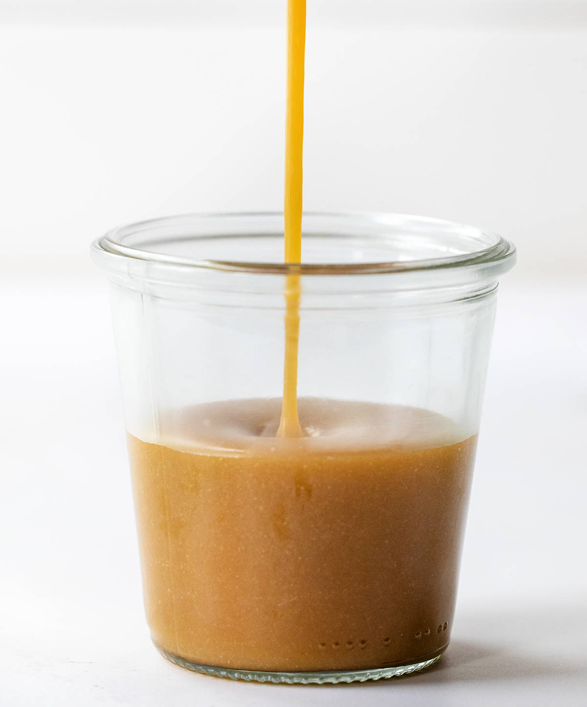 Pouring Butterscotch Sauce into a Glass Jar.