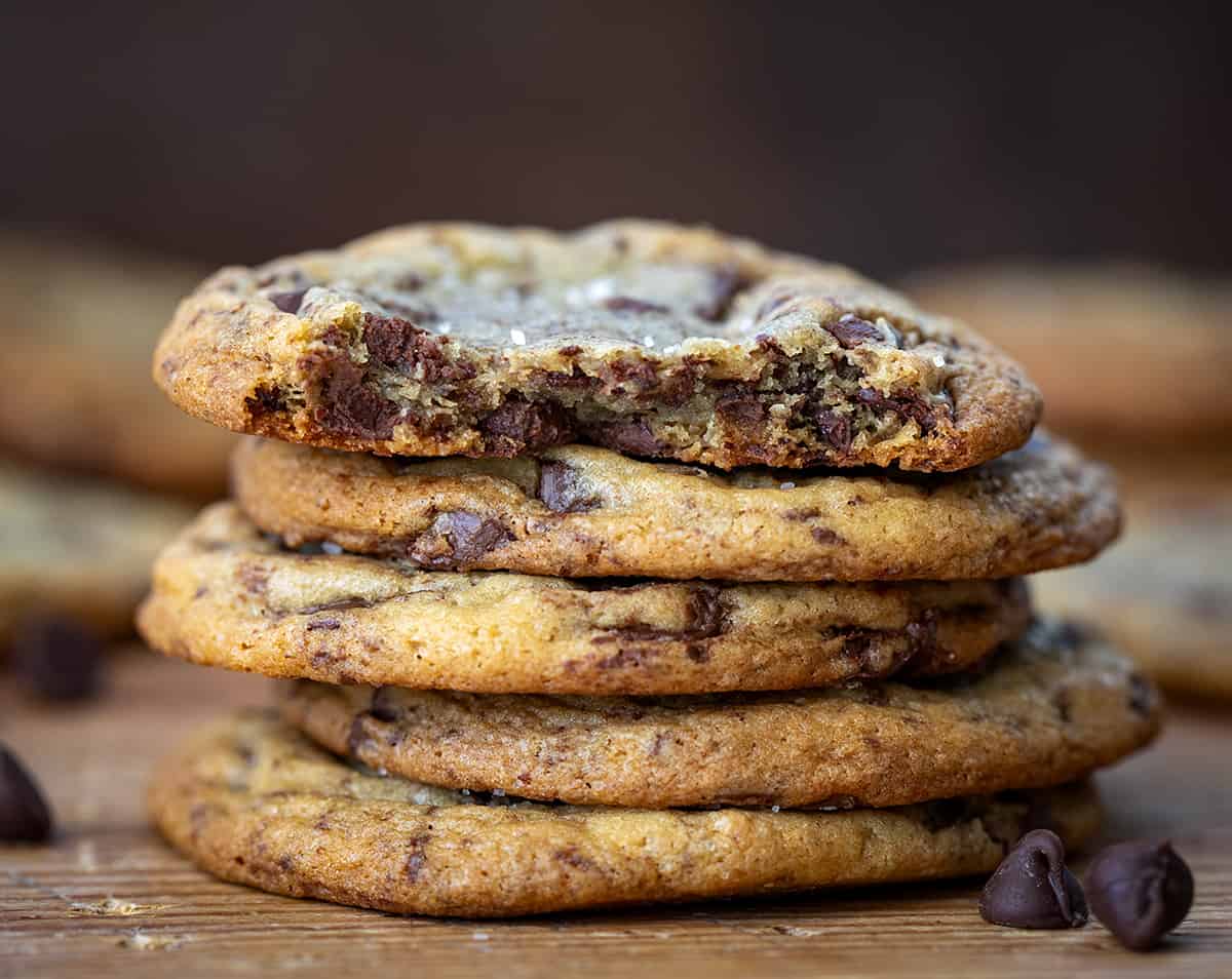 Stack of Browned Butter Chocolate Chip Cookies with Top Cookie Broken in Half Showing Inside.