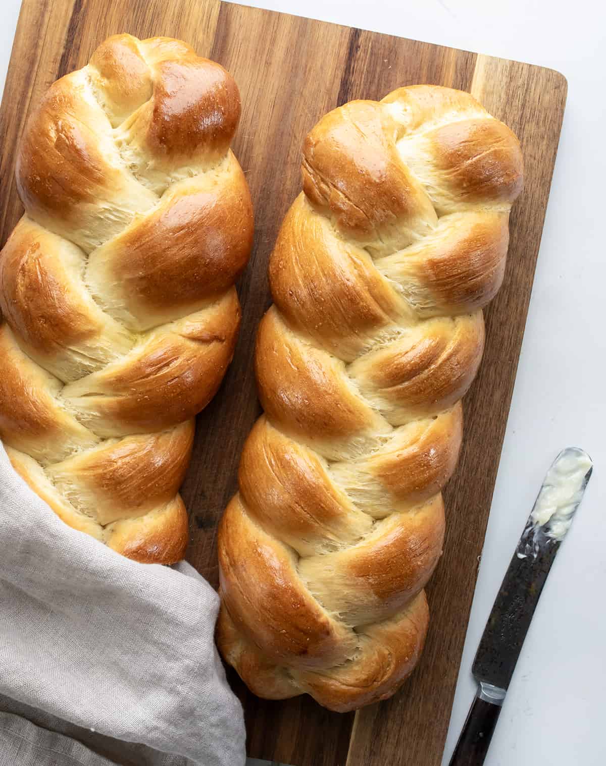 Easy Challah Bread on White Counter with a Butter.