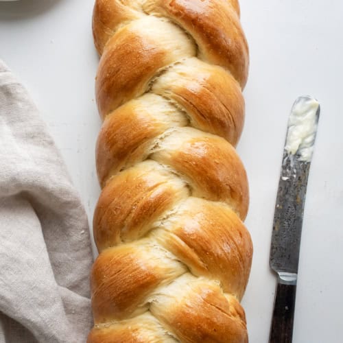 Easy Challah Bread on White Counter with a Butter.