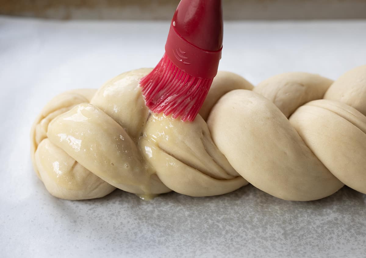 Brushing Braided Challah Bread Before Baking.