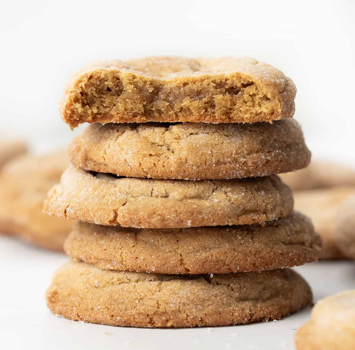 Stack of Chewy Peanut Butter Cookies with Top Cookie Broken in Half Showing Inside TExture.