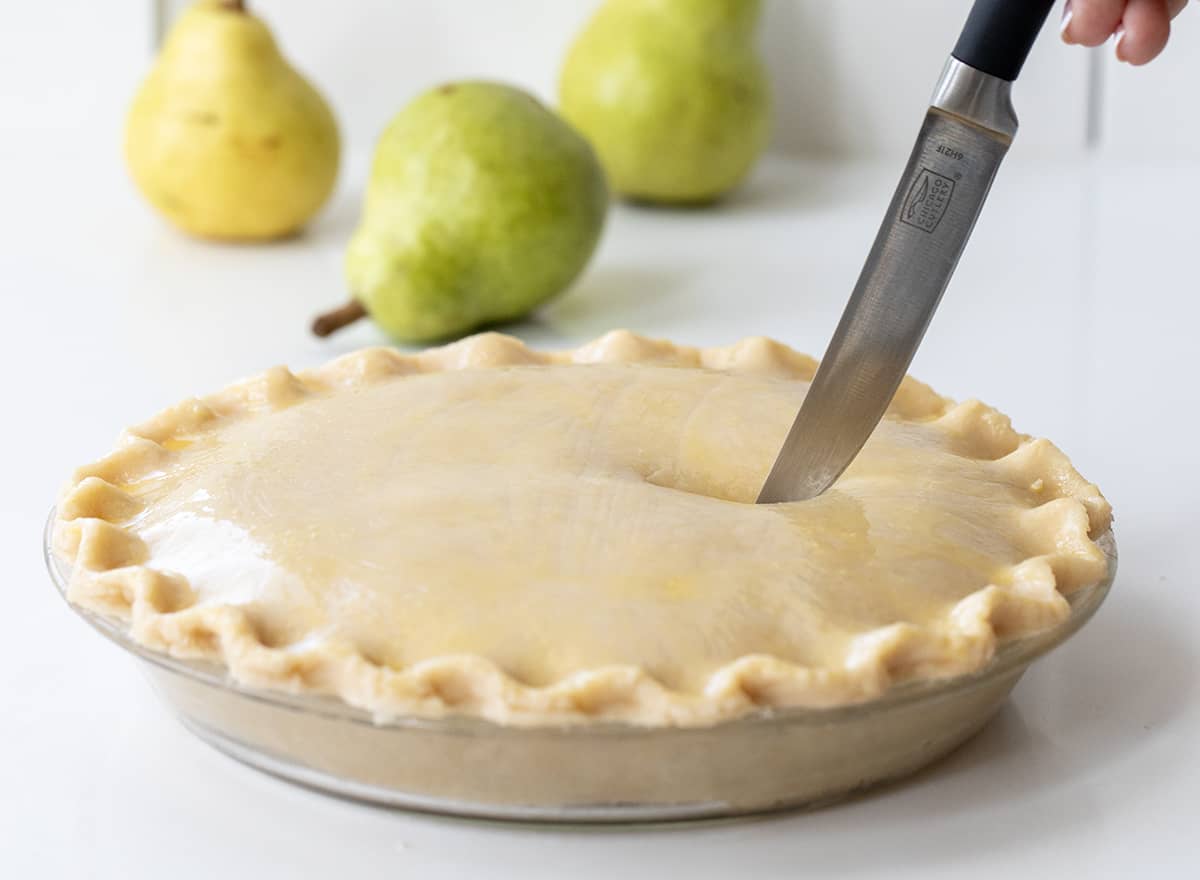 Cutting Slits into an Unbaked Pear Pie.