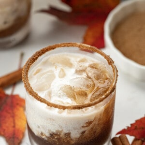 Glasses of Pumpkin Spice White Russian Cocktail with Leaves.