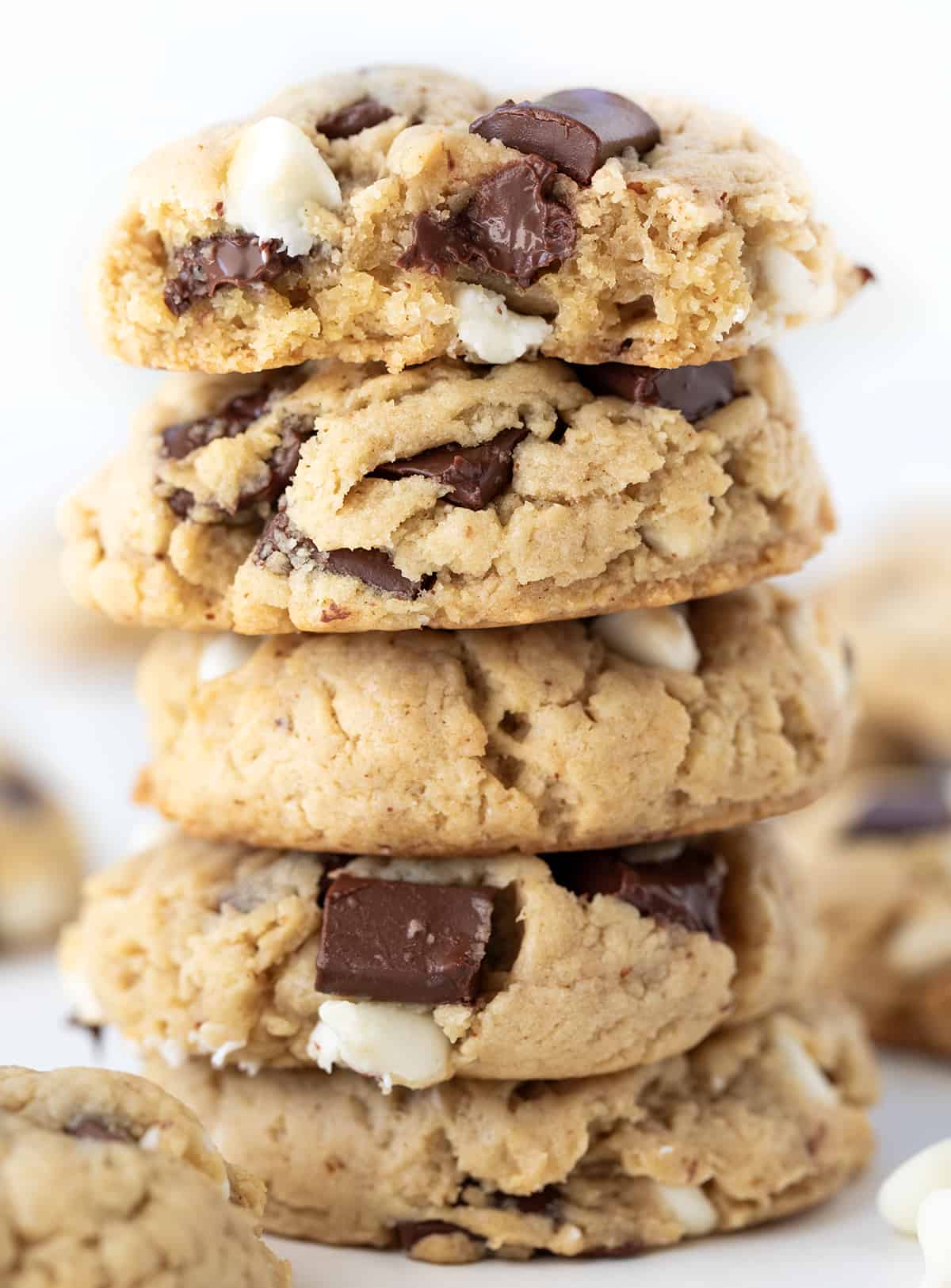 Stack of Browned Butter Soft Batch Chocolate Chip Cookies with Top Cookie Halved to Show Inside Texture.
