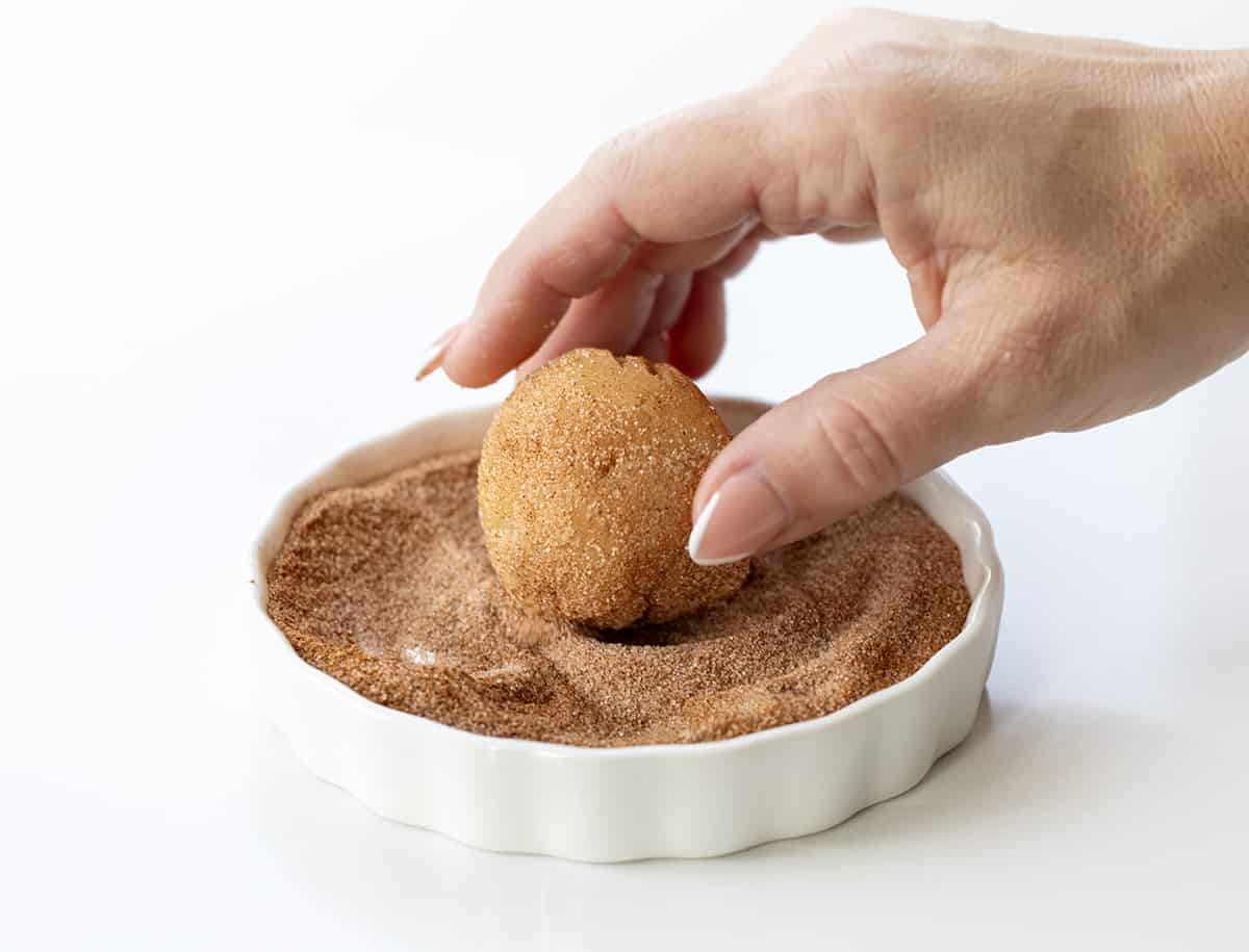 Rolling Snickerdoodle Dough Ball in Cinnamon Sugar.