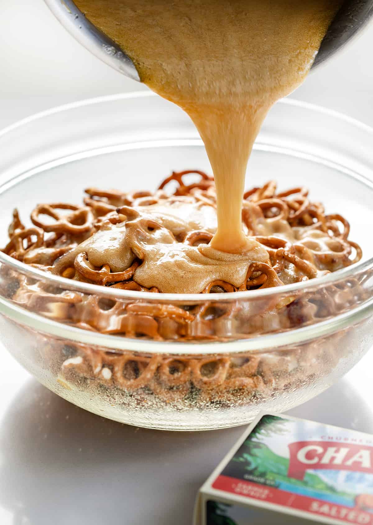 Pouring toffee over pretzels to make Butter Toffee Pretzels.
