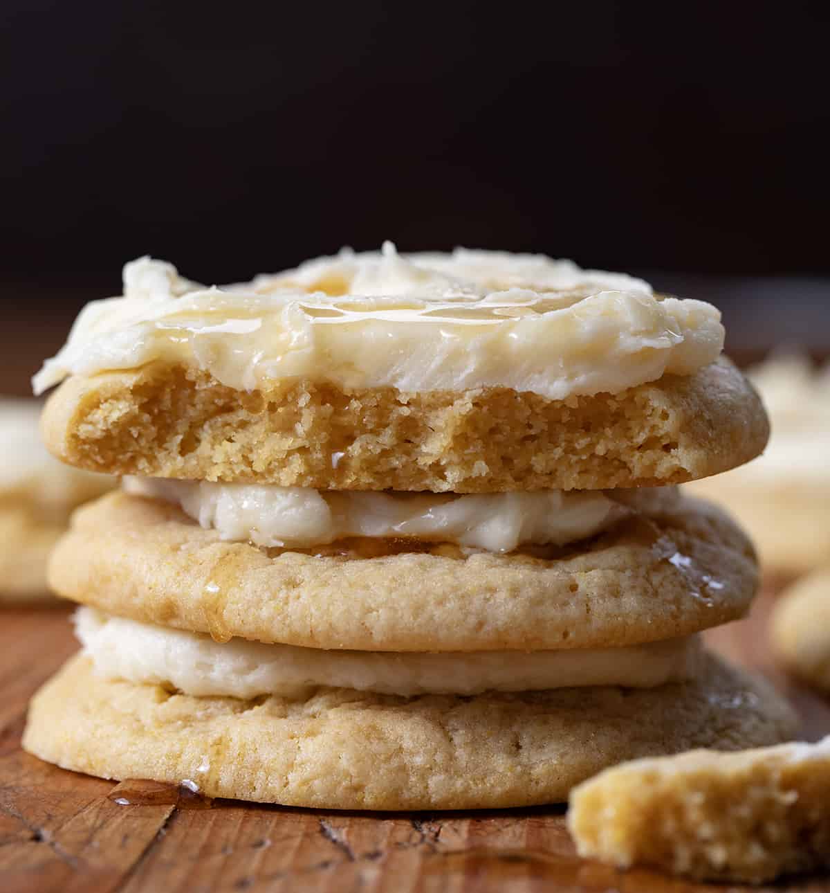 Stack of Cornbread Cookies with top cookie halved showing tender inside texture.