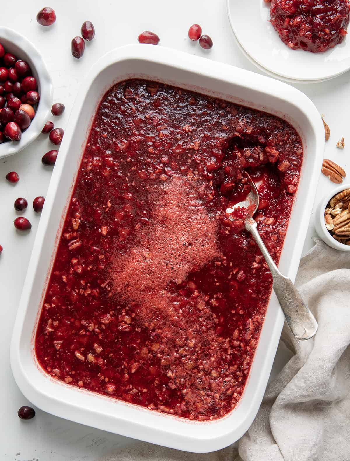 Pan of Cranberry Jello Salad with a spoon in it. 