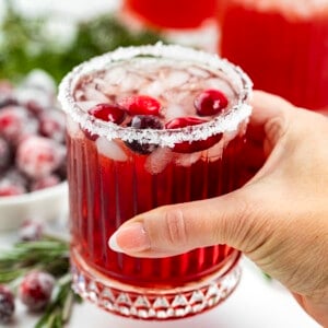 Hand holding a Cranberry Margarita.