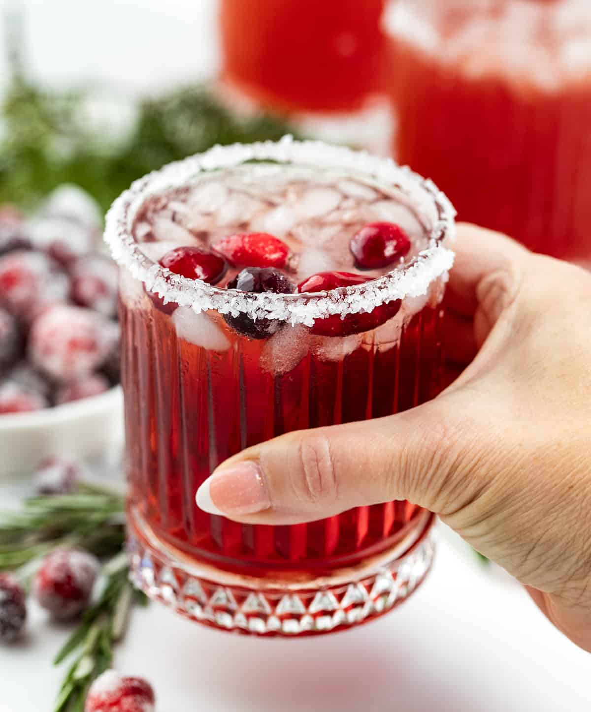 Hand holding a Cranberry Margarita.