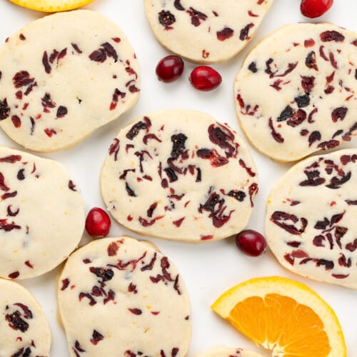 Cranberry Orange Shortbread Cookies from overhead with oranges and cranberries.