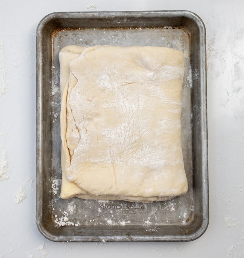 Folding OVer Dough to Laminate to Make Cruffins.