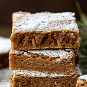 Stack of Gingerbread Brownies showing texture on a wooden table.
