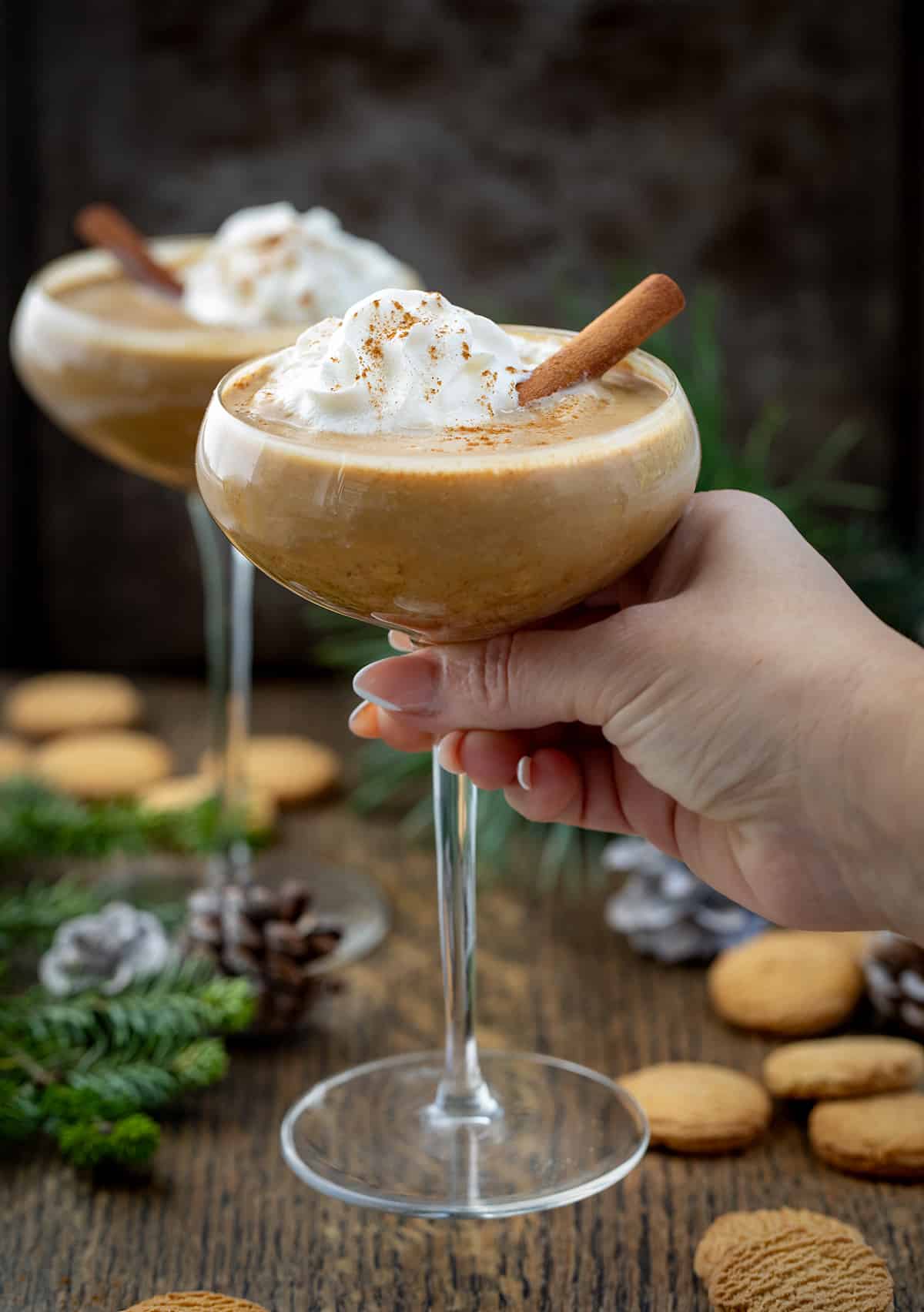 Hand picking up a Gingerbread Martini.