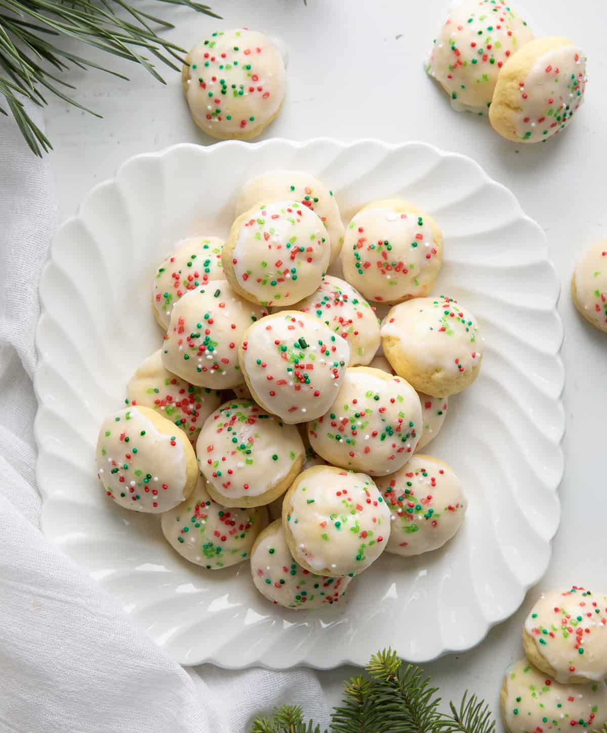 Plate of Italian Christmas Cookies from overhead on a white table.