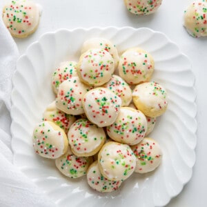 Plate of Italian Christmas Cookies from overhead on a white table.
